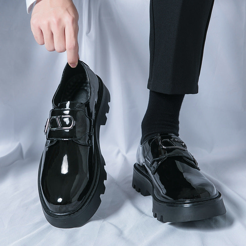 Glossy black platform loafers with strap buckle and thick platform sole