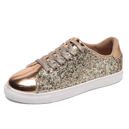 Gold and bronze sequin lace-up board shoes with white rubber sole, low profile.