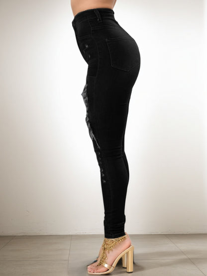 Black high-waist skinny jeans, full-length view with ripped detailing on thigh