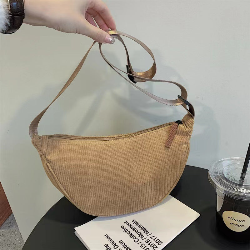 Beige large dumpling crossbody bag with adjustable strap and corduroy texture