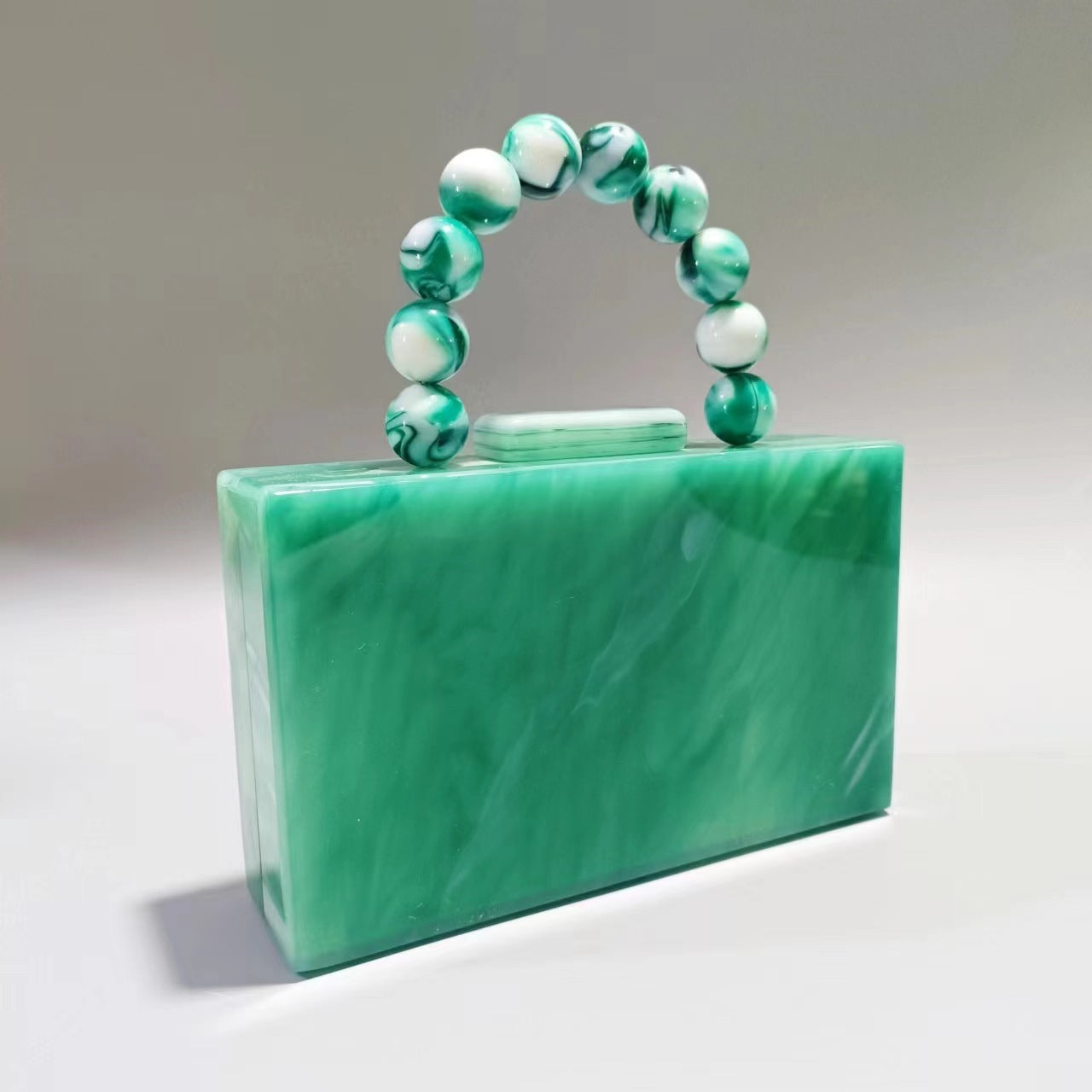 Women's acrylic evening bag with translucent green body and green bead handle