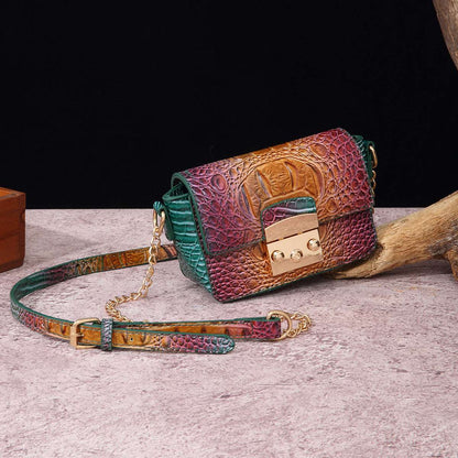 Multicolor one-shoulder crossbody bag with green and maroon textured panels, gold clasp, chain strap.