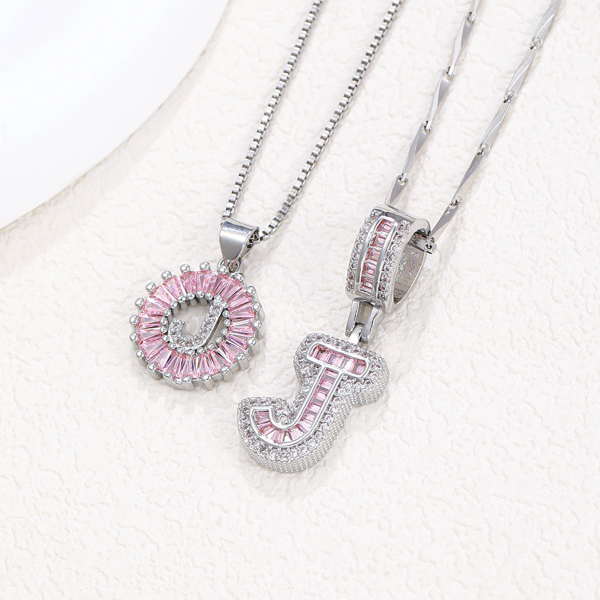 Silver pendant necklace set with pink crystal flower circle charm and letter charm, clasp close-up