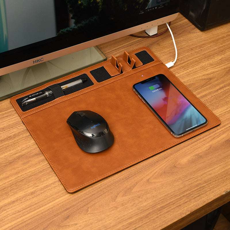 Brown leather desk mat with phone, mouse, and other items on a wooden desk.
