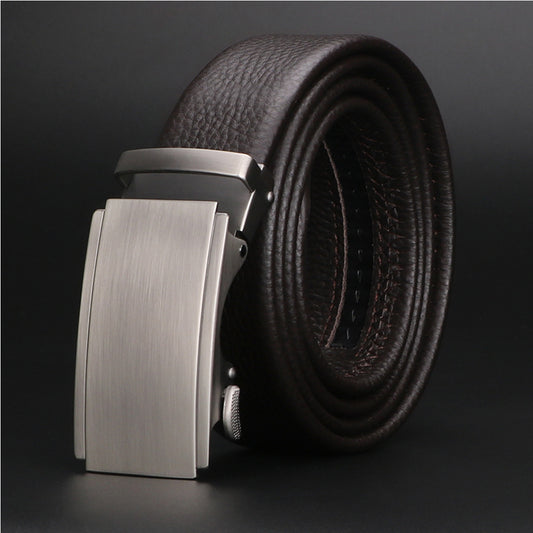 A close-up of a men's high-quality leather belt featuring a sleek automatic sliding buckle, styled with both formal suit trousers and casual chinos.