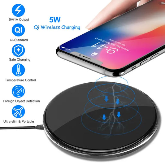 A high-angle view of a sleek, black ultra-slim wireless charging pad with a non-slip surface, successfully charging an iPhone XS Max without cables.