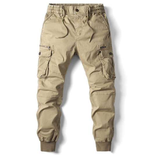 A man modeling slim-fit skinny working pants in a solid earth tone, highlighting the tactical multi-pocket design and rugged fabric texture.
