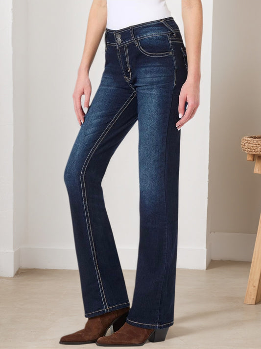 A pair of retro navy blue jeans featuring high-stretch fabric, detailed embroidery on the back pockets, and a classic metal button closure.