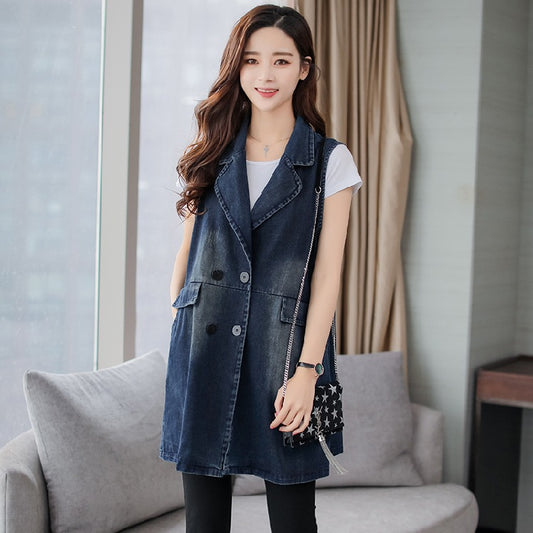 A woman modeling a mid-length sleeveless vest coat over a long-sleeve sweater, showing a sophisticated layered look for spring or autumn.