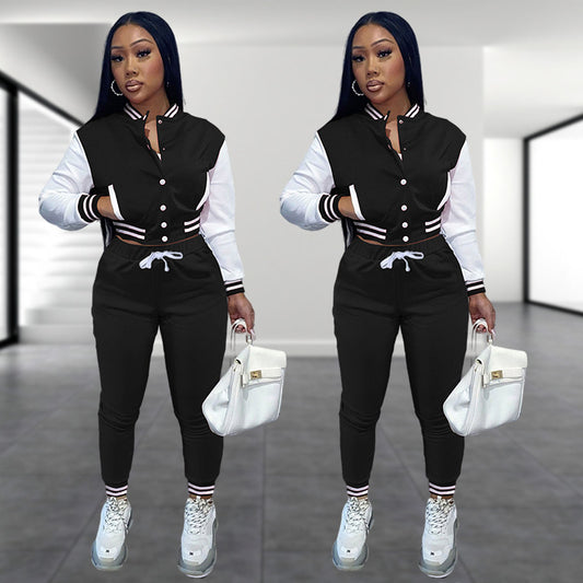 A woman modeling a two-piece sports set featuring a single-breasted baseball jacket with contrast stitching and matching athletic pants.