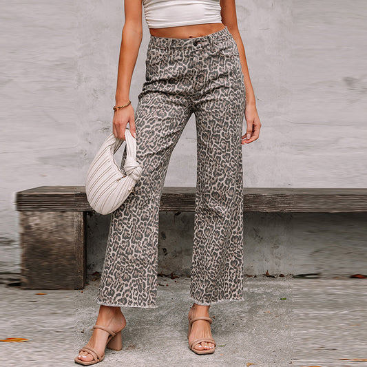 A woman modeling high-waisted denim jeans with unique frayed hem details and a personalized distressed wash, inspired by Western street fashion trends.