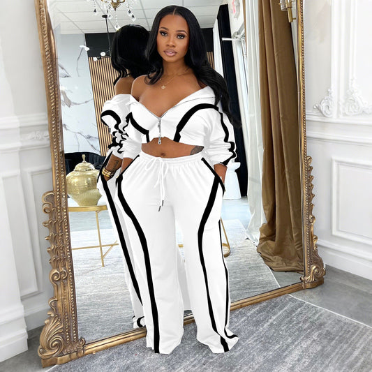 A woman wearing a coordinated two-piece set featuring a long-sleeve zip-up cardigan with contrast-color piping and matching high-waisted jogger pants.