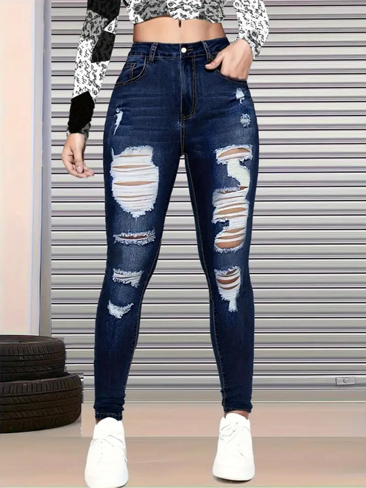 A woman wearing light-wash, high-waisted skinny jeans with ripped knees and a nine-quarter ankle crop, styled with a minimalist white tank top.