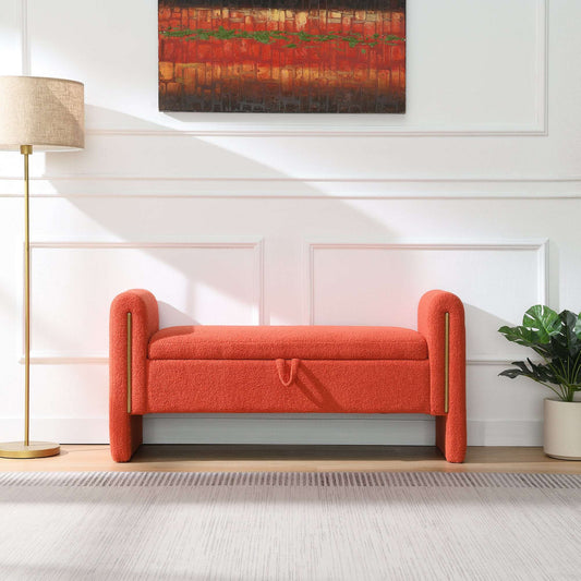 Bright orange teddy upholstered bed-end bench featuring curved arms and a lift-top storage compartment in a modern bedroom setting.