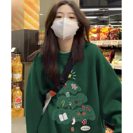 Person wearing a green sweater with a Christmas tree design in a store setting