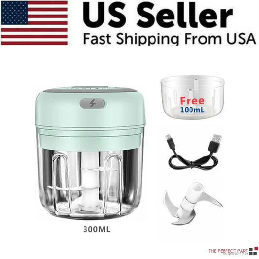 Compact 300ml electric garlic chopper on a kitchen counter, showing the stainless steel blades mincing fresh garlic cloves and red chili peppers