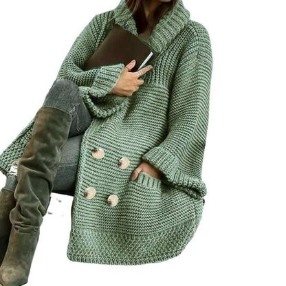 Green knitted coat worn by a person on a white background