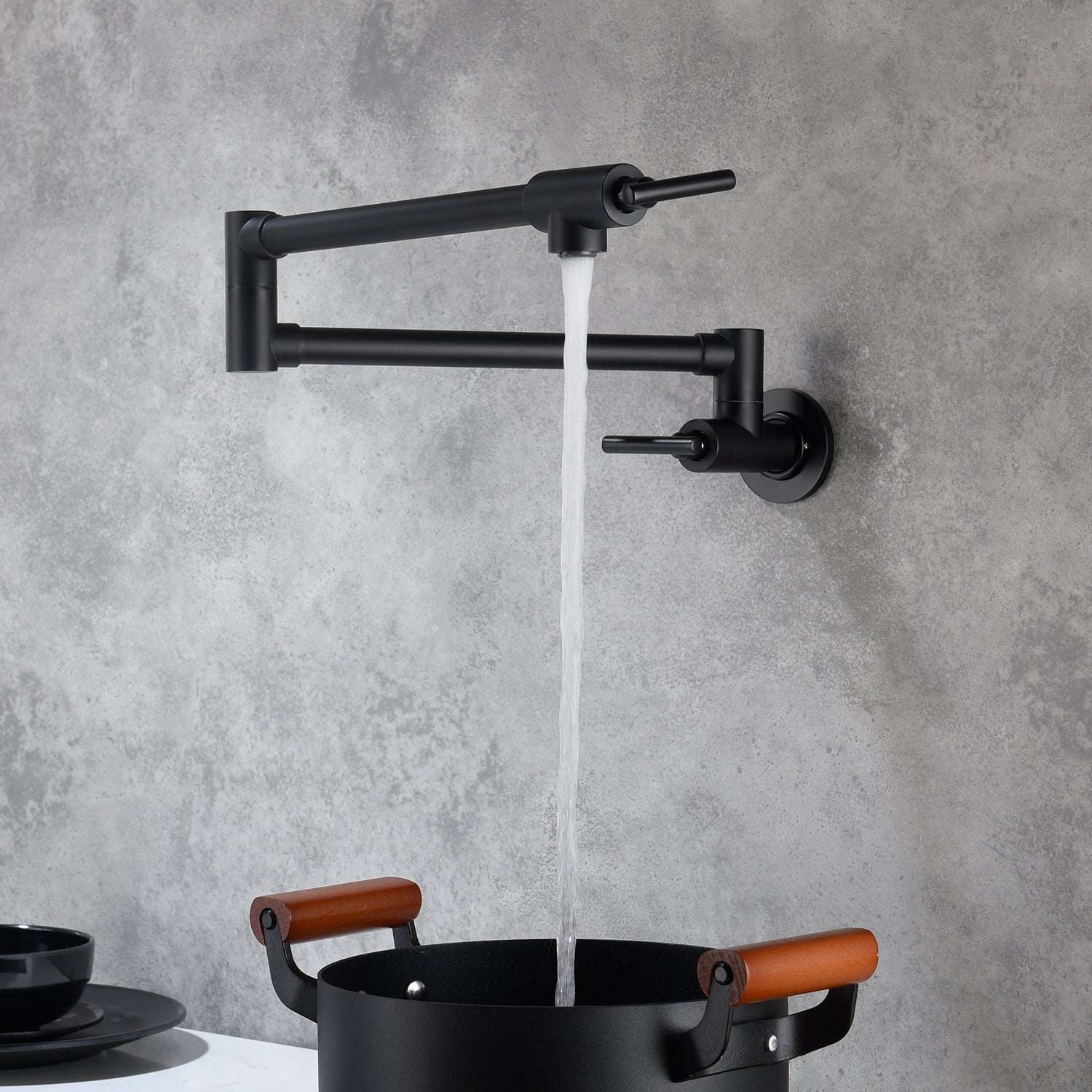 Matte black wall-mount pot filler faucet with folding spout and side control