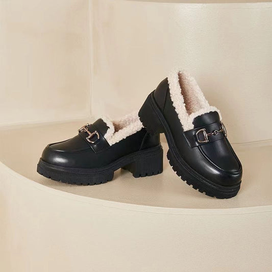 A pair of black fleece-lined women's shoes with a platform and chunky sole.