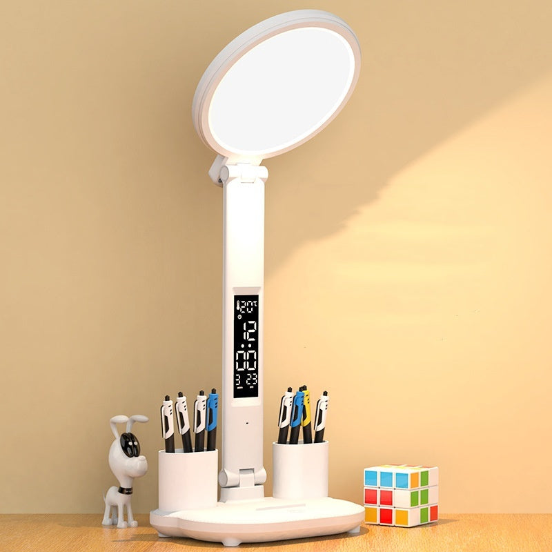 White desk lamp with oval LED light head, fan grille, and digital display with pen cups