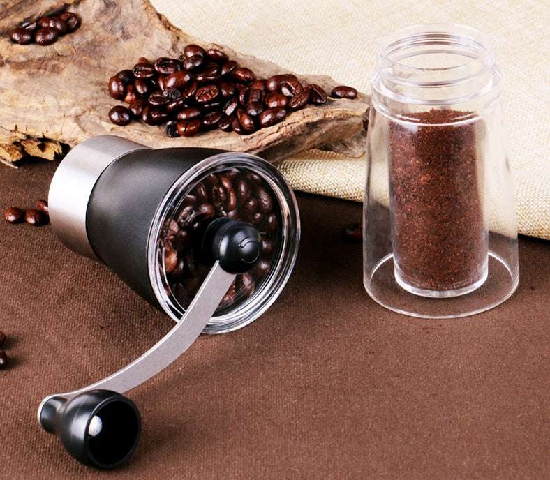 Coffee grinder with coffee beans and ground coffee in a jar on a brown surface.