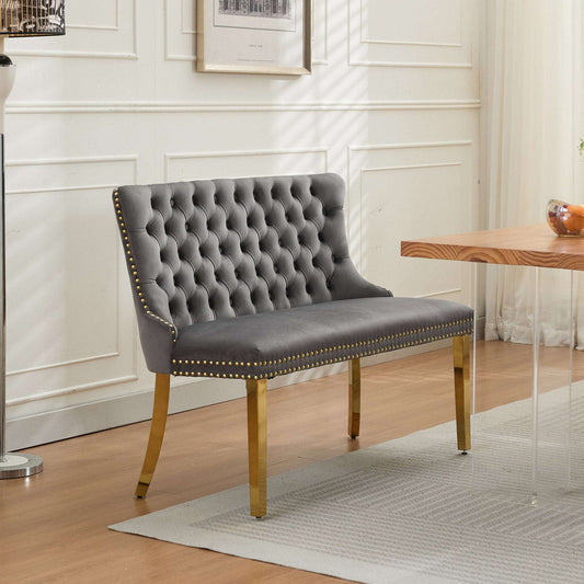 Mid-century modern gray velvet 2-seat dining bench featuring handmade button tufting, a high wingback, and polished gold-plated steel legs.