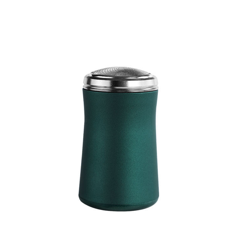 Green shaker with silver top on a white background