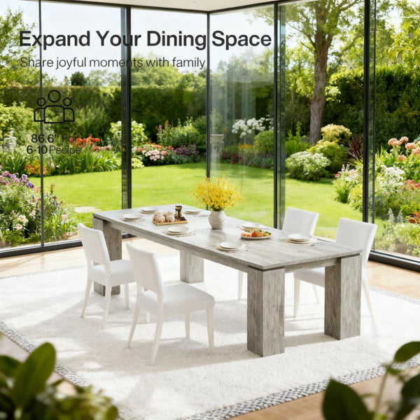 Rectangular light gray wood dining table with four thick legs, seating for 4-6