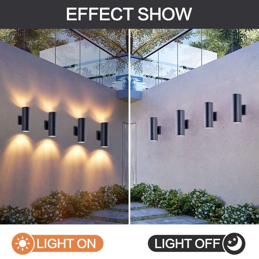 Matte black cylinder outdoor wall lights with warm up-down glow on exterior wall