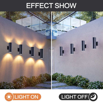 Matte black cylinder outdoor wall lights with warm up-down glow on exterior wall