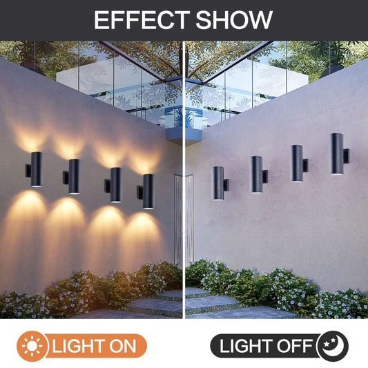 Modern matte black aluminum cylinder up down outdoor wall lights installed on a porch wall at night