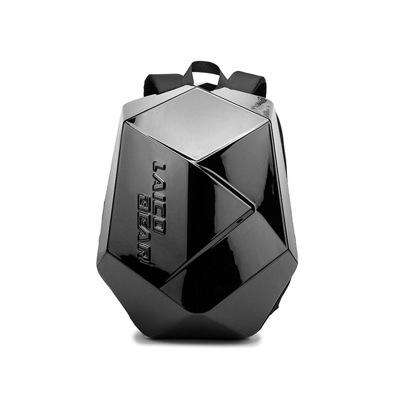 A black hard shell backpack with a carbon fiber pattern, featuring a top handle and the brand name 'MOTO' on the front.