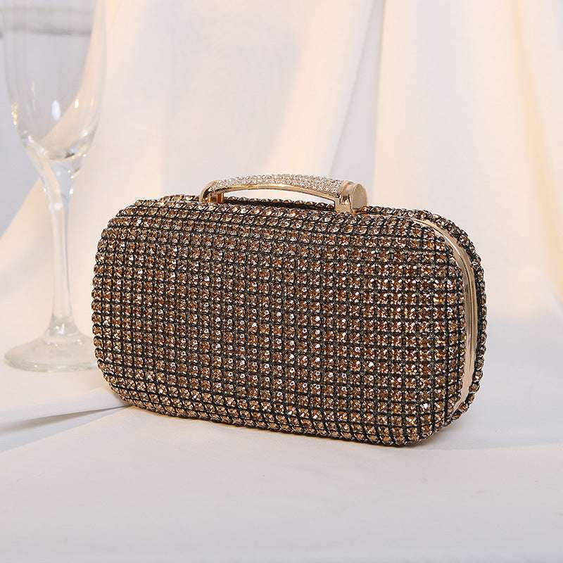 Gold-tone rhinestone clutch bag with gold-tone top handle and chain strap