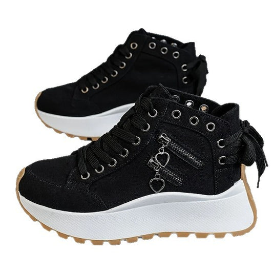 Black high-top sneakers with white soles on a white background