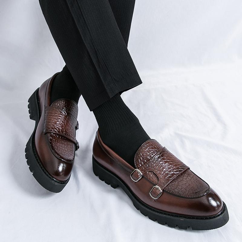 Men's brown leather slip-on loafers with buckled straps and lugged platform sole