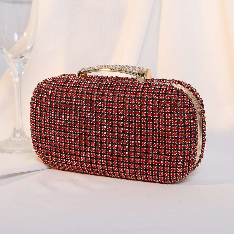 Red rhinestone clutch bag with gold-tone top handle and curved clasp front