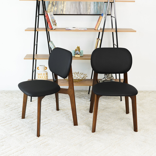 Pair of modern black leather dining chairs with a minimalist silhouette, measuring 18.1 inches wide and 31.7 inches high.
