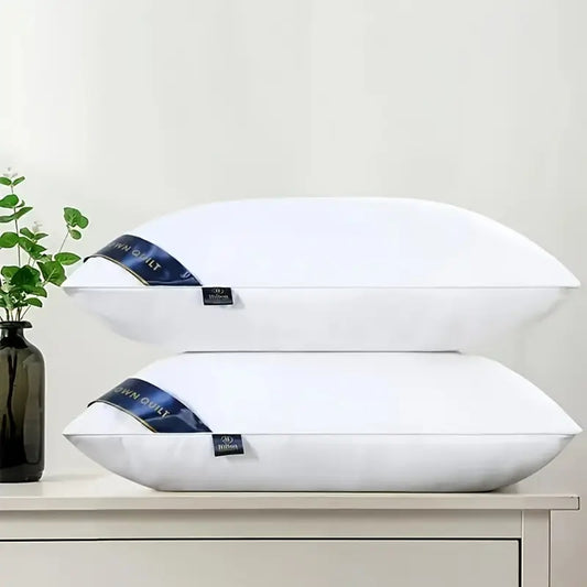 Pair of plush navy blue bed pillows neatly arranged on a white bedsheet in a modern bedroom