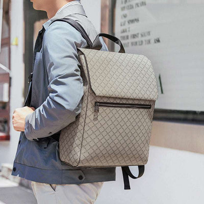 Khaki patterned backpack with front zipper, top flap, and black shoulder straps