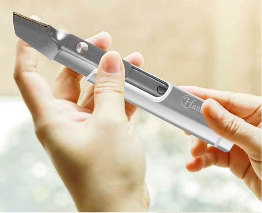 Hand holding a silver and black electronic device 