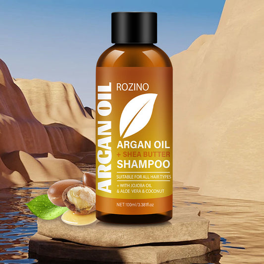 Bottle of Rozino Argan Oil and Shea Butter Shampoo with desert landscape in the background