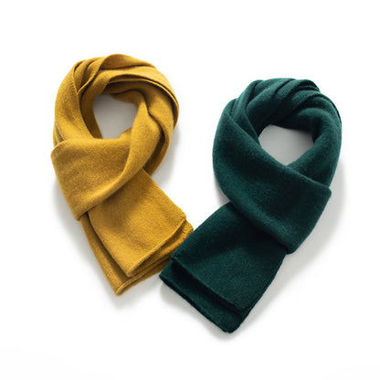 Two scarves, one yellow and one green, on a white background