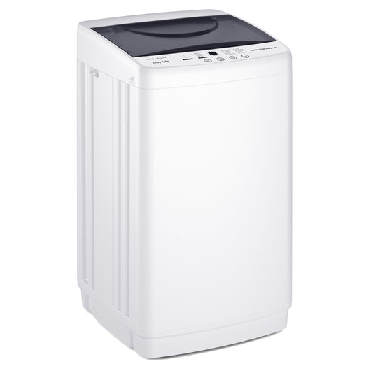 White compact portable washing machine with an LED display and stainless steel tub in a small apartment laundry corner