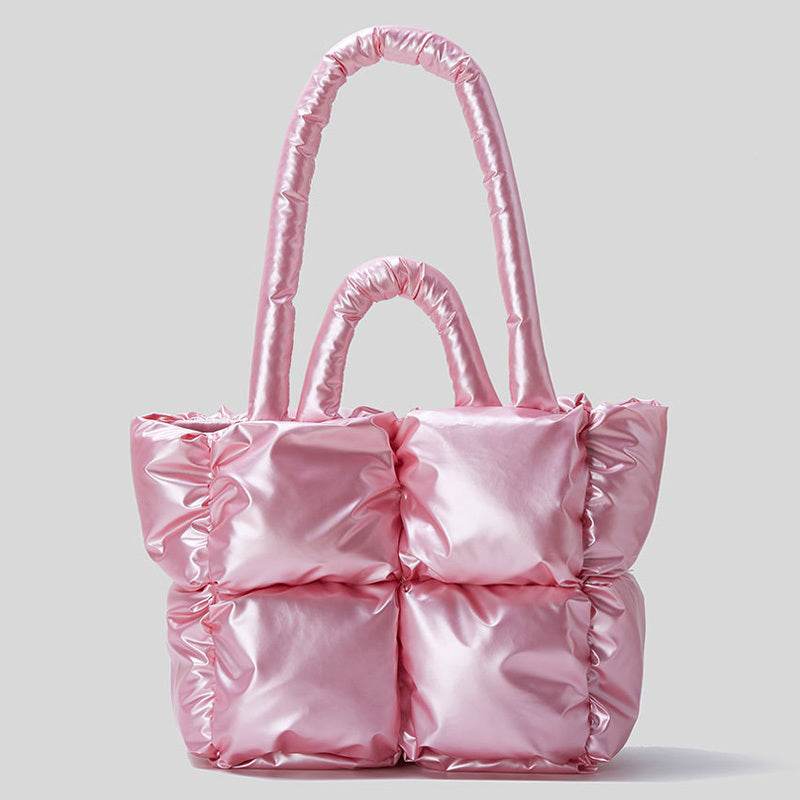 Puffer one-shoulder handbag in pink with quilted panels and tall top handles