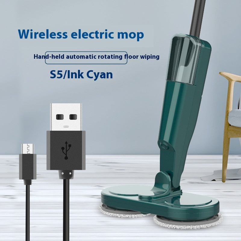 Green wireless electric mop with USB cable on a wooden floor background