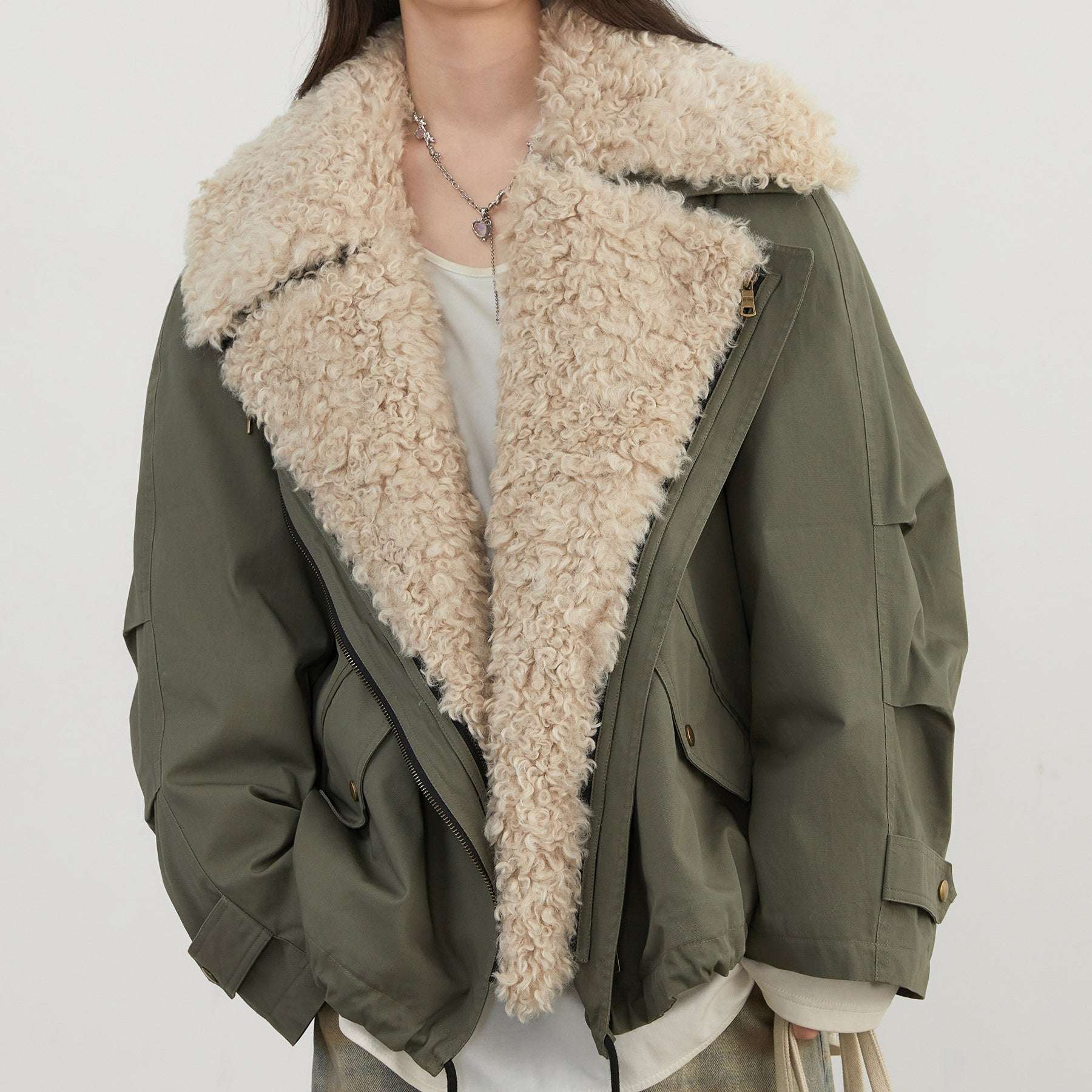 Green jacket with beige sherpa lining on a white background