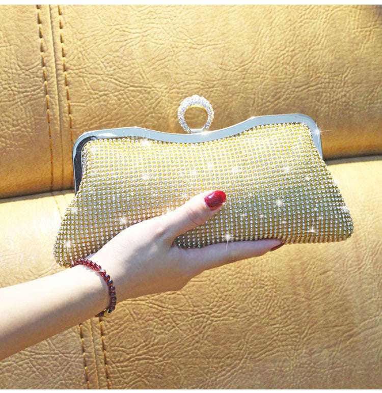 Gold rhinestone clutch bag with kiss-lock frame and loop handle