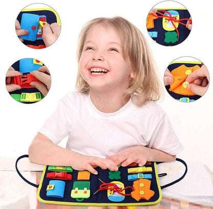 Child playing with a colorful educational mat with various shapes and letters.