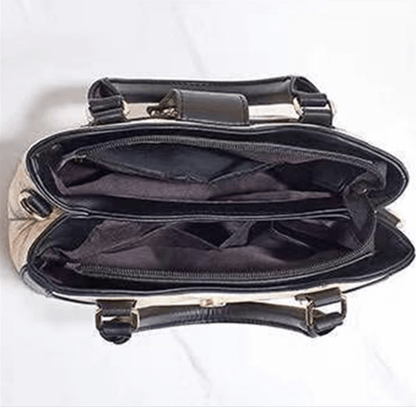 Open black handbag interior with zip pocket and adjustable strap hardware