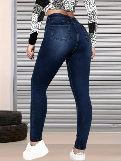 High-waisted dark blue ripped jeans with back yoke seam and light wash distressing